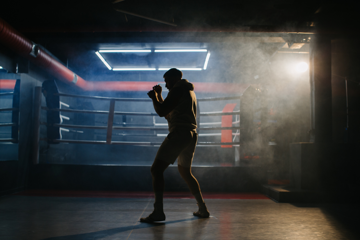 Athlete performing shadow boxing workout with proper stance and form in training space